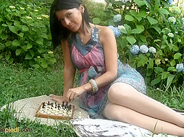 Lovely barbara playing chess outdoors and...