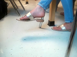 Pretty feet dangling sandals in class...