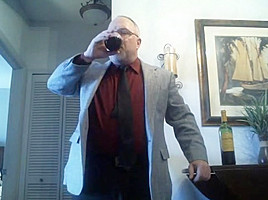 Mature suit strip with red wine...