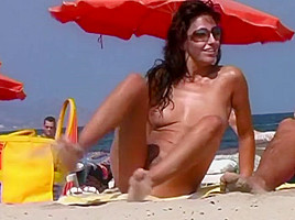 Sexy brunette at nude beach...
