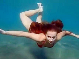 Julia is swimming underwater nude sea...