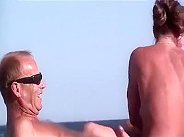 Nudist beach handjob and brunette voyeur...