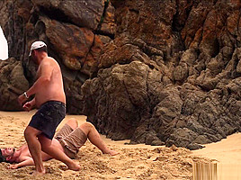 Men Wrestling On The Beach...