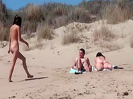 Sunbathing at nudist beach two couple...